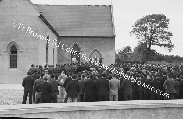 MEN AT CLOSING SERMON OUTSIDE THE CHURCH